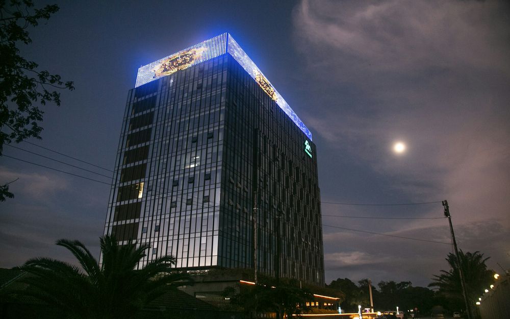 Sun Share Building, a glass office tower in Lusaka, Zambia, lit at night