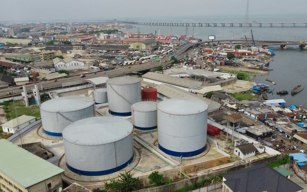 Aerial view of industrial storage tanks beside a busy road in Lagos